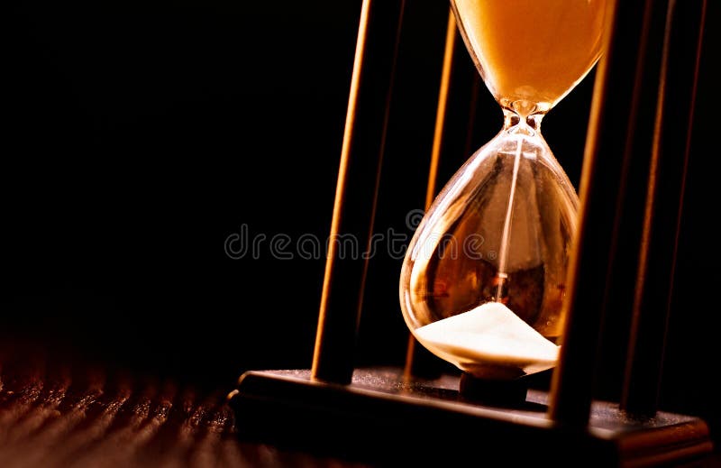 Newly turned hourglass with running sand royalty free stock images