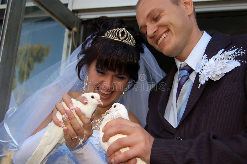 Newly wedded couple with doves