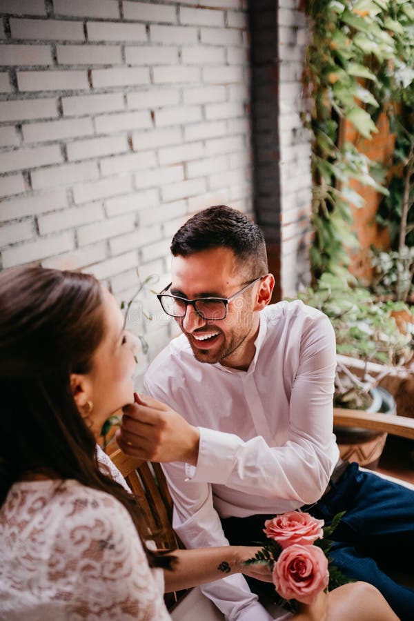 Newlywed couple caressing and looking at each other and smiling on their wedding day. Love concept stock photos Newlywed couple caressing and looking at each other and smiling on their wedding day. Love concept stock photos