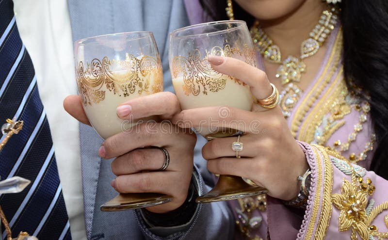 newlyweds Arabian in their hands cups of milk.