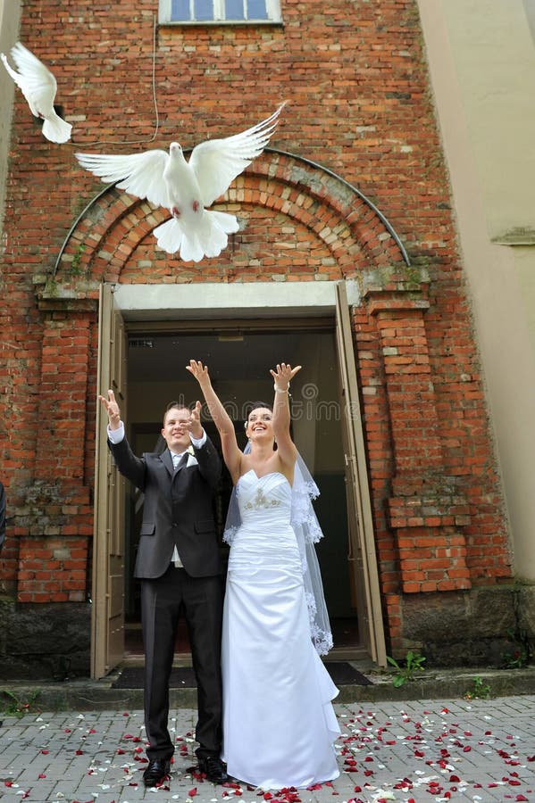 Newlyweds with doves