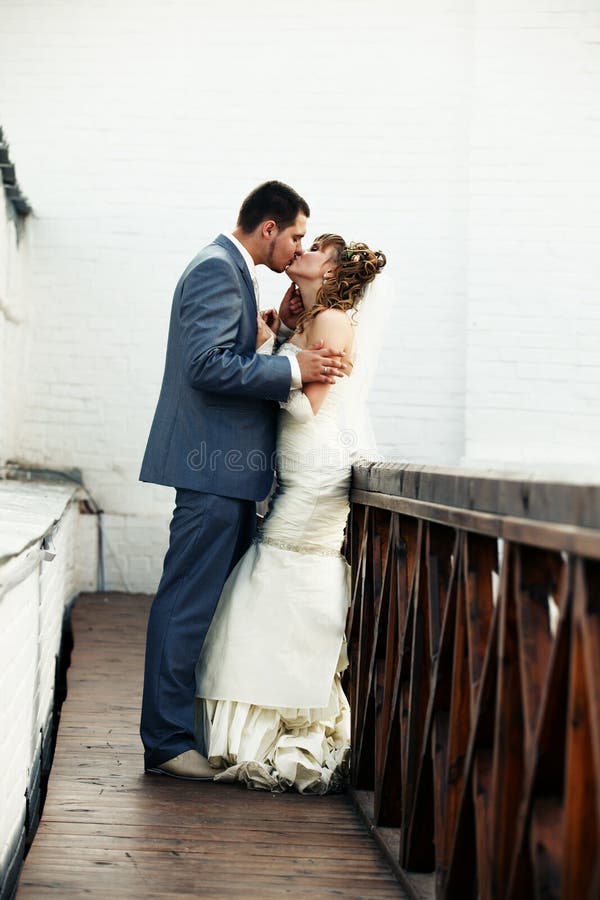 Newlyweds kissing stock photo