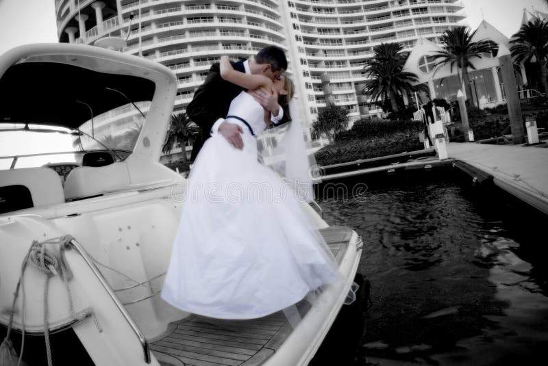 Newlyweds kissing on boat