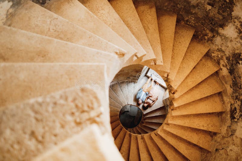 Newlyweds Lie Holding Hands on the Spiral Staircase of the Ancient ...