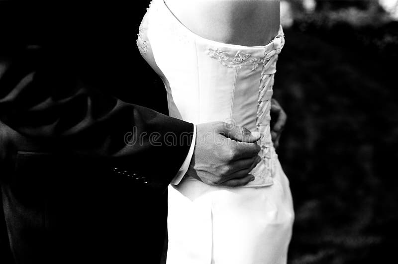 Bride and groom holding hands on wedding day. Bride and groom holding hands on wedding day