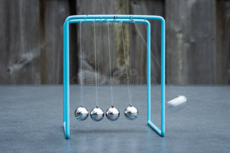 Newtons cradle, physics experiment: collision balls in action. Blurred motion. royalty free stock image Newtons cradle, physics experiment: collision balls in action. Blurred motion. royalty free stock image