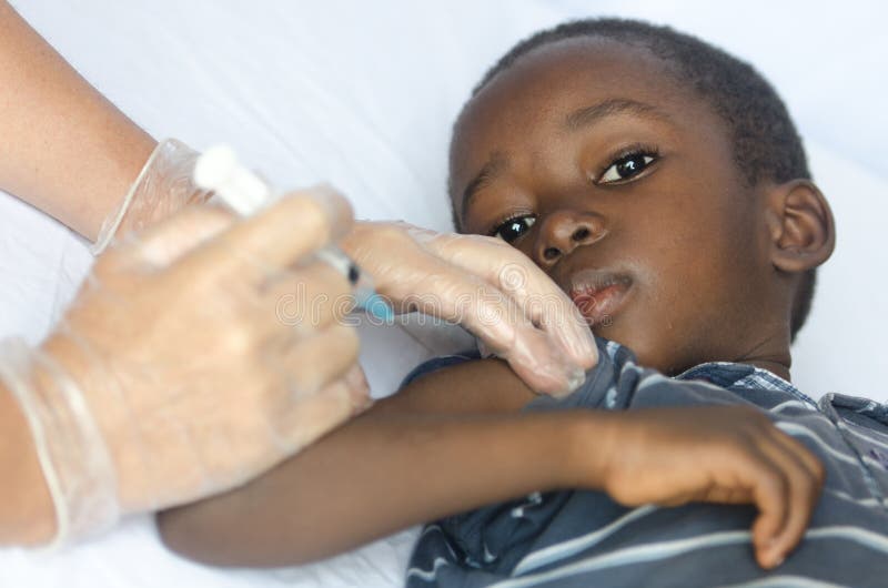 Sad African boy is worried about getting an injection for his health as a vaccination stock images Sad African boy is worried about getting an injection for his health as a vaccination stock images