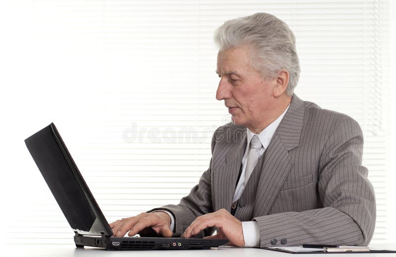 Nice elderly man sitting at the laptop