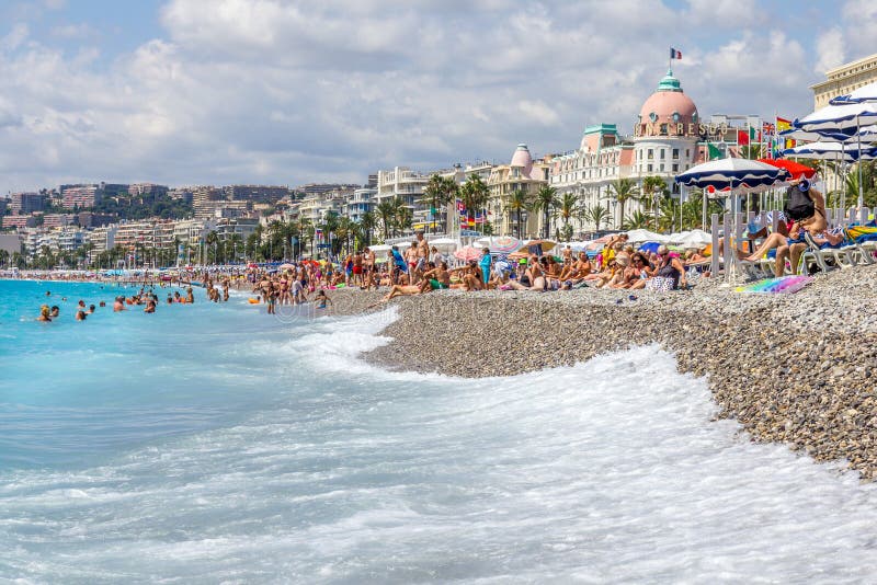 Tourists Enjoy the Good Weather at the Beach in Nice, France Editorial