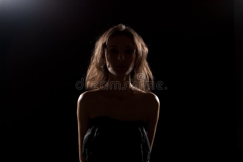 Nice girl in studio. Silhouette.