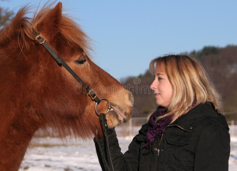 Nice girl talking to her horse