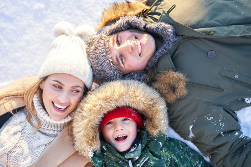 Nice happy family having fun on winter snow