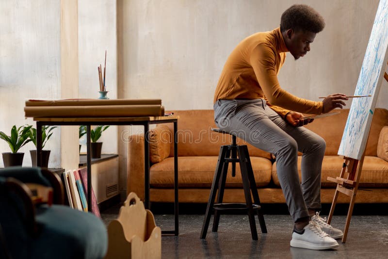 Nice hard working artist concentrating on his painting royalty free stock photos Nice hard working artist concentrating on his painting royalty free stock photos