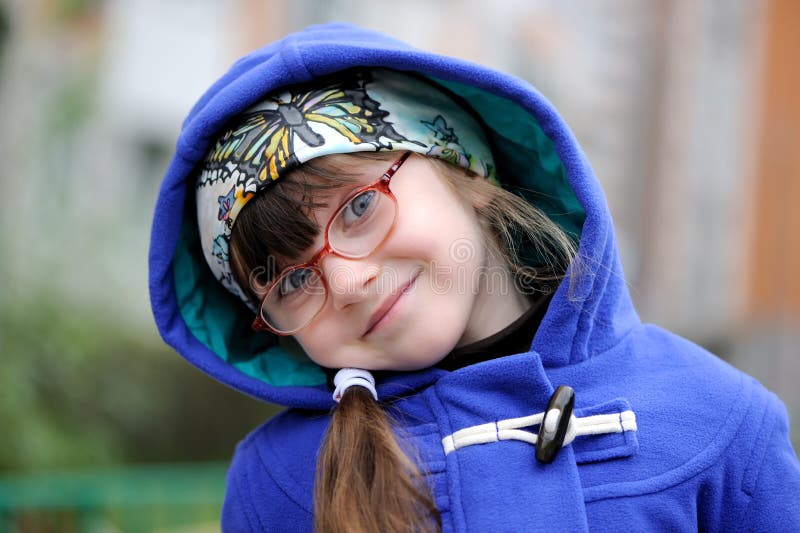 Nice little girl in hood ofblue coat