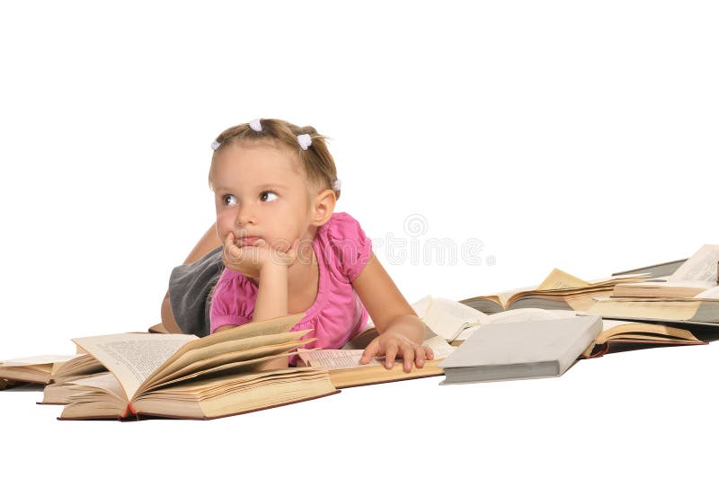 Nice little girl lying on pile of books