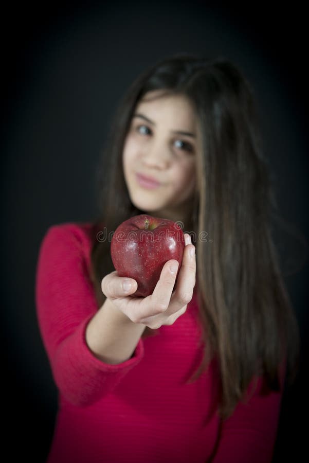 Portrait of Little Girl Offering an Apple