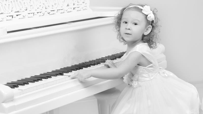 child's baby grand piano white