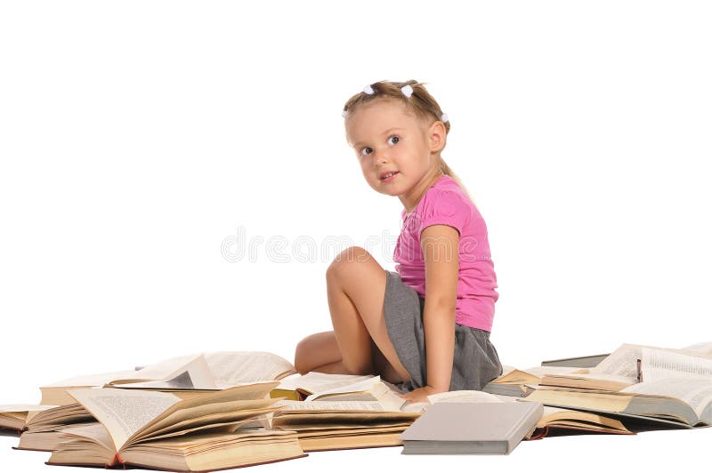 Nice little girl sitting on pile of books