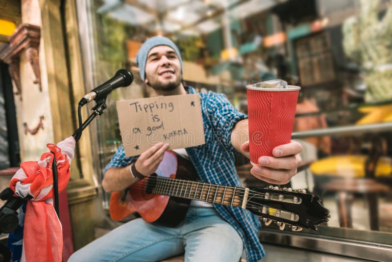 Nice male musician pleading for tips after play stock images Nice male musician pleading for tips after play stock images
