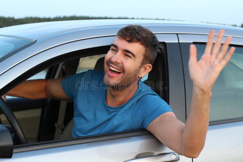 Nice man greeting someone while driving