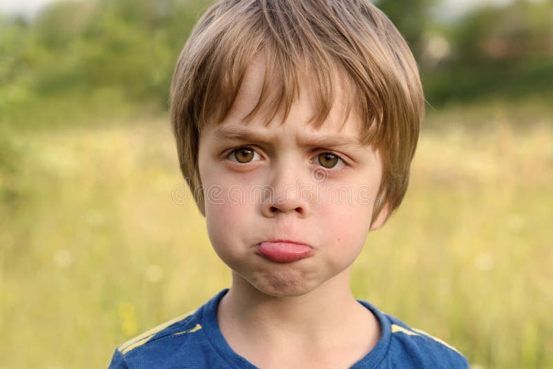 Nice Offended Boy with Insulted Expression Face, Purses His Lips in