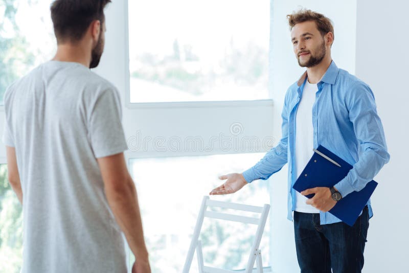 Nice pleasant therapist looking at his patient