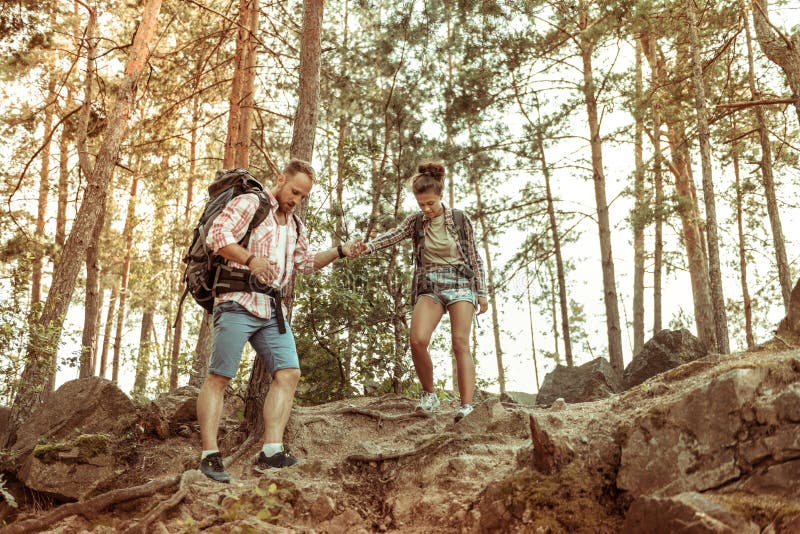 Nice pleasant young couple going down together royalty free stock images Nice pleasant young couple going down together royalty free stock images