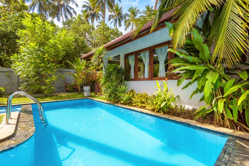 Nice pool in backyard of luxury tropical hotel or residential house