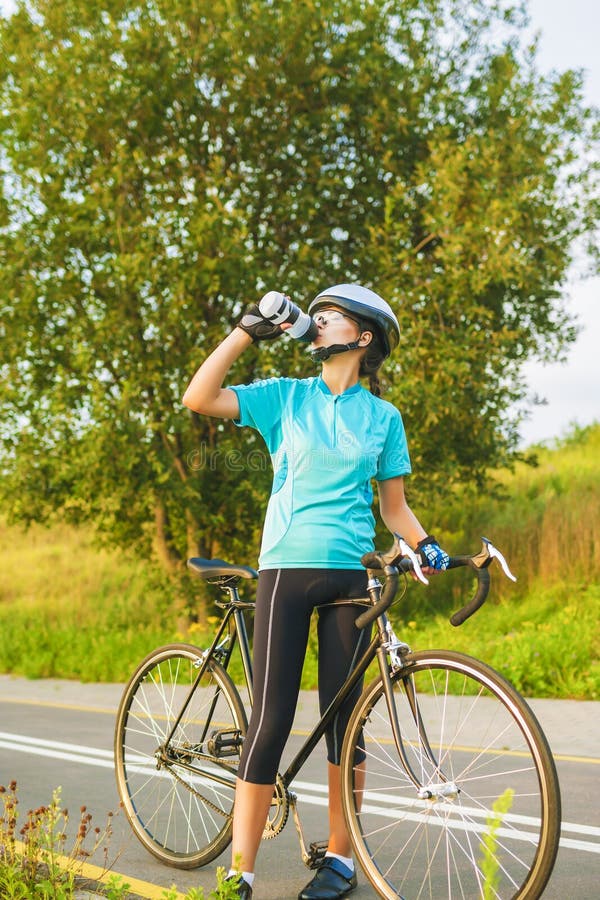 Nice Portrait of Young Female Cyclist Athlete Having a Break. Stock
