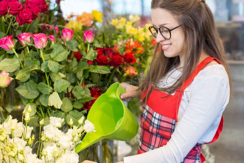 Nice positive flower seller holding water can stock photos Nice positive flower seller holding water can stock photos