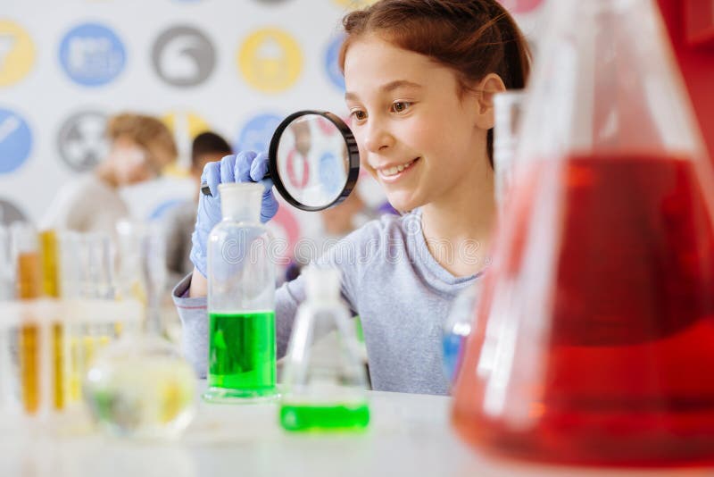 Cheerful Girl Examining Result of Chemical Reaction with Magnifying ...