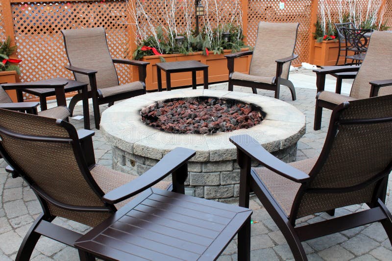 Nice stone fireplace with outdoor chairs. stock photos