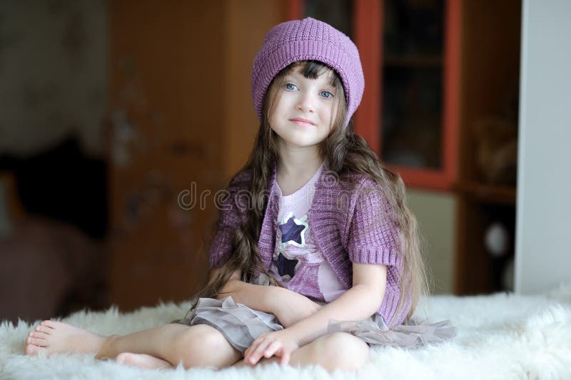 Nice toddler girl in purple hat