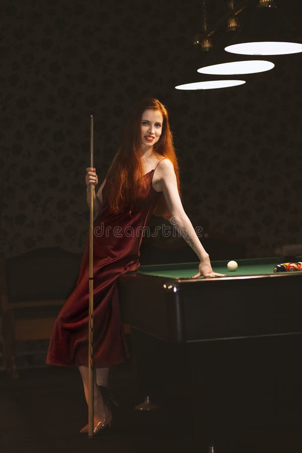 The nice young girl with cue at a billiard table. Retro design