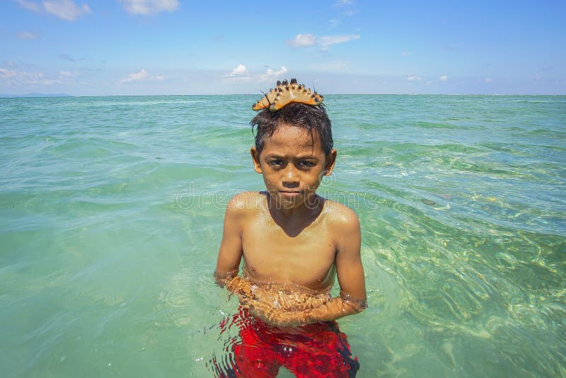 Nicht identifiziertes Bajau Laut scherzt auf einem Boot in Maiga-Insel