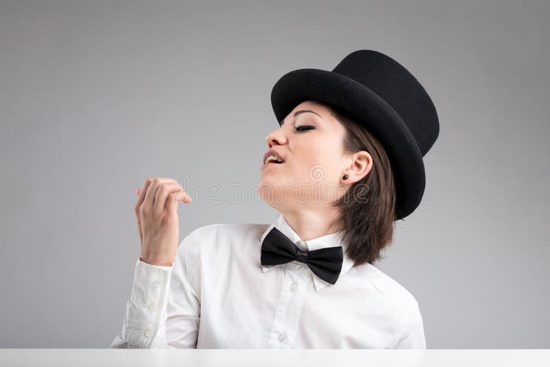 Vain woman in top hat showing herself off and. Vain woman in top hat showing herself off and