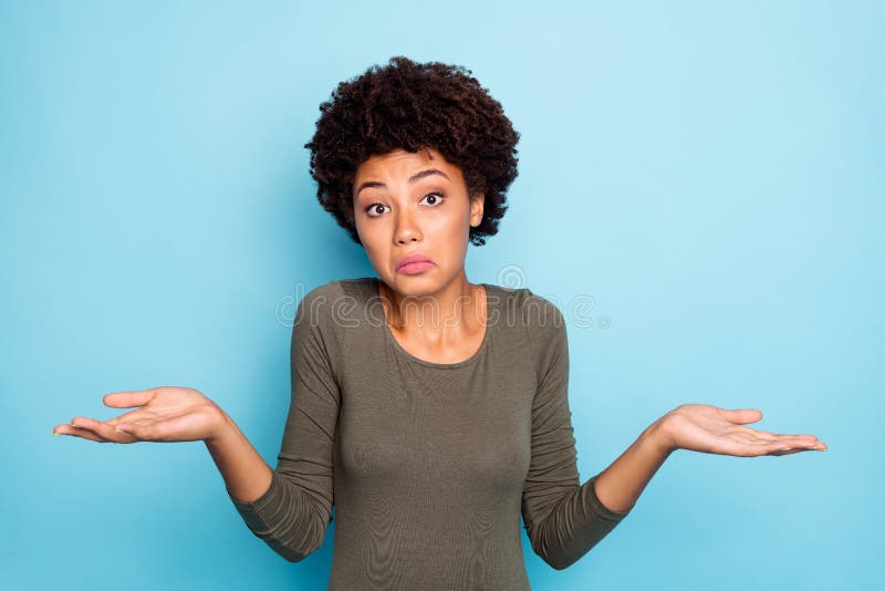 I dont care. Portrait of doubtful negative curly hair afro american girl cant choose, answer solve trouble shrug shoulders hold hands hesitate wear beautiful outfit isolated blue color background. I dont care. Portrait of doubtful negative curly hair afro american girl cant choose, answer solve trouble shrug shoulders hold hands hesitate wear beautiful outfit isolated blue color background