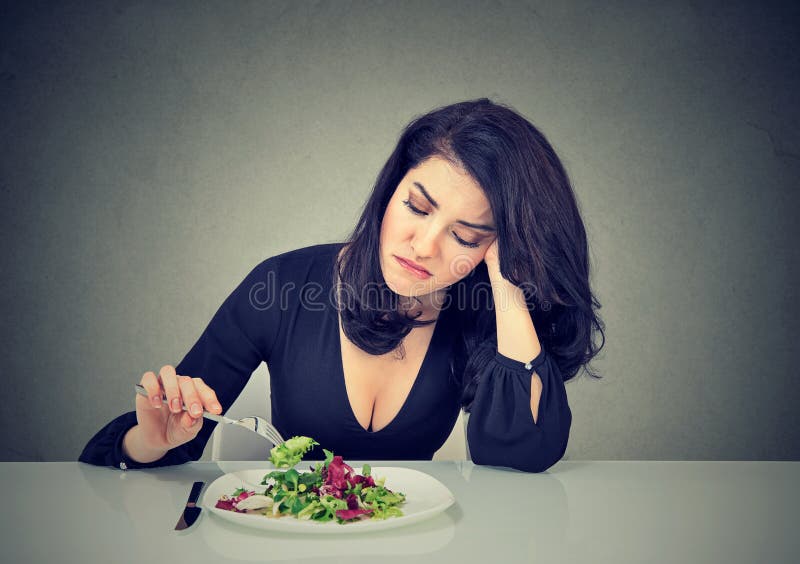 Nierada kobiety łasowania zieleni liścia sałata męczył diet ograniczenia fotografia royalty free Nierada kobiety łasowania zieleni liścia sałata męczył diet ograniczenia fotografia royalty free