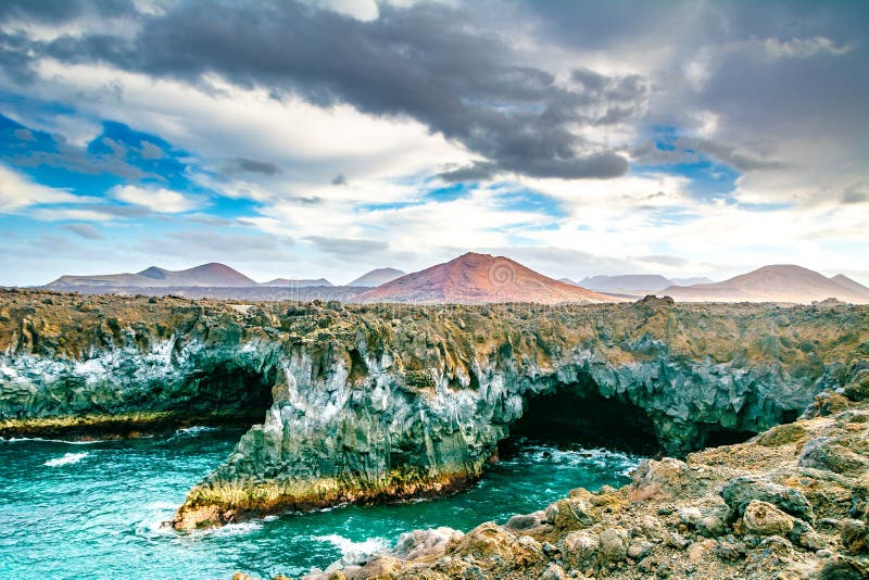 Amazing view of lava`s caves Los Hervideros and volcanoes in Lanzarote island, popular touristic attraction. Location: Lanzarote, Canary Islands, Spain. Artistic picture. Beauty world. Amazing view of lava`s caves Los Hervideros and volcanoes in Lanzarote island, popular touristic attraction. Location: Lanzarote, Canary Islands, Spain. Artistic picture. Beauty world.