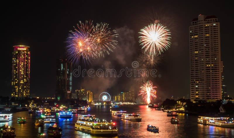 BANGKOK - JANUARY 1: New year countdown celebration fireworks along Chaophraya river, view from Taksin bridge in Bangkok, Thailand, on January 1, 2016. BANGKOK - JANUARY 1: New year countdown celebration fireworks along Chaophraya river, view from Taksin bridge in Bangkok, Thailand, on January 1, 2016.