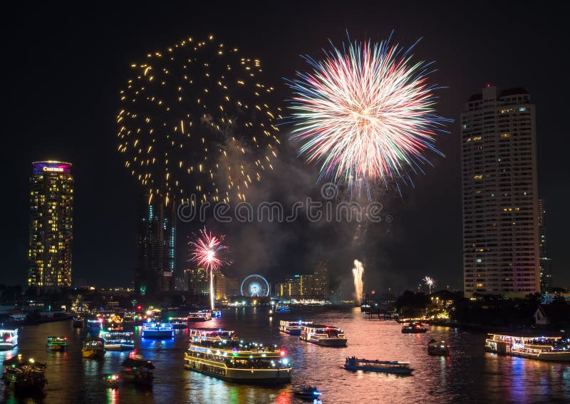 BANGKOK - JANUARY 1: New year countdown celebration fireworks along Chaophraya river, view from Taksin bridge in Bangkok, Thailand, on January 1, 2016. BANGKOK - JANUARY 1: New year countdown celebration fireworks along Chaophraya river, view from Taksin bridge in Bangkok, Thailand, on January 1, 2016.