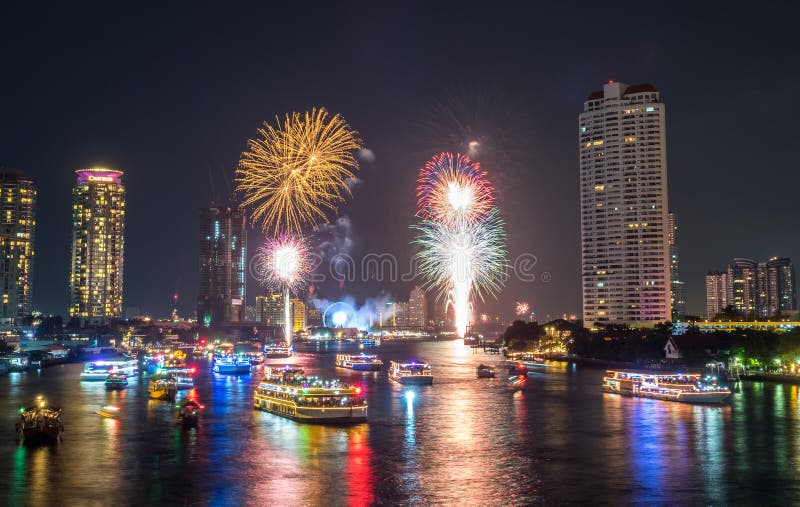 BANGKOK - JANUARY 1: New year countdown celebration fireworks along Chaophraya river, view from Taksin bridge in Bangkok, Thailand, on January 1, 2016. BANGKOK - JANUARY 1: New year countdown celebration fireworks along Chaophraya river, view from Taksin bridge in Bangkok, Thailand, on January 1, 2016.