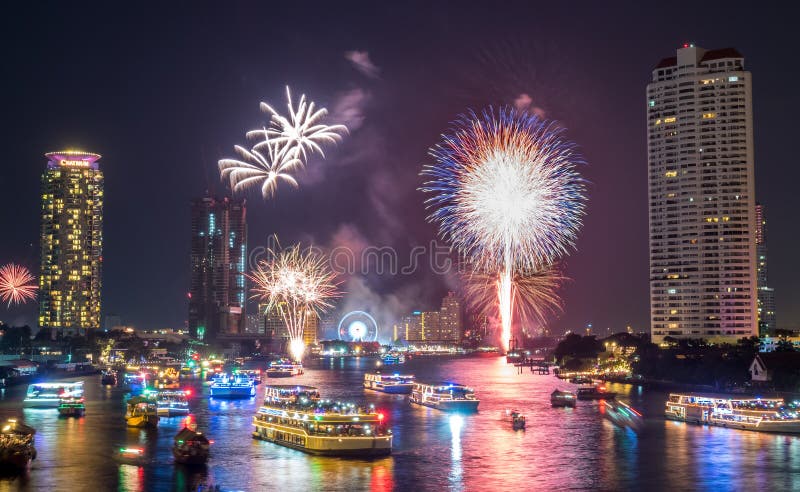 BANGKOK - JANUARY 1: New year countdown celebration fireworks along Chaophraya river, view from Taksin bridge in Bangkok, Thailand, on January 1, 2016. BANGKOK - JANUARY 1: New year countdown celebration fireworks along Chaophraya river, view from Taksin bridge in Bangkok, Thailand, on January 1, 2016.