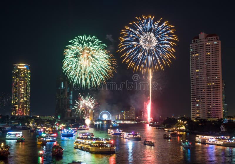 BANGKOK - JANUARY 1: New year countdown celebration fireworks along Chaophraya river, view from Taksin bridge in Bangkok, Thailand, on January 1, 2016. BANGKOK - JANUARY 1: New year countdown celebration fireworks along Chaophraya river, view from Taksin bridge in Bangkok, Thailand, on January 1, 2016.