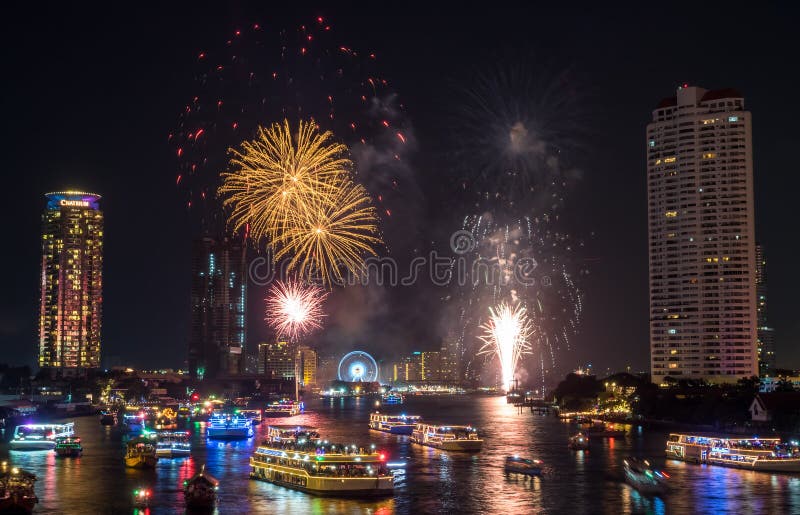 BANGKOK - JANUARY 1: New year countdown celebration fireworks along Chaophraya river, view from Taksin bridge in Bangkok, Thailand, on January 1, 2016. BANGKOK - JANUARY 1: New year countdown celebration fireworks along Chaophraya river, view from Taksin bridge in Bangkok, Thailand, on January 1, 2016.