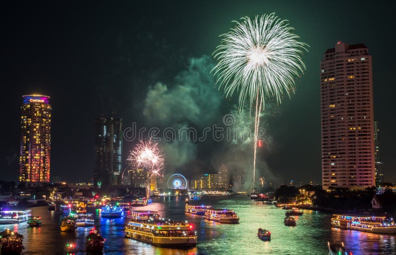 BANGKOK - JANUARY 1: New year countdown celebration fireworks along Chaophraya river, view from Taksin bridge in Bangkok, Thailand, on January 1, 2016. BANGKOK - JANUARY 1: New year countdown celebration fireworks along Chaophraya river, view from Taksin bridge in Bangkok, Thailand, on January 1, 2016.