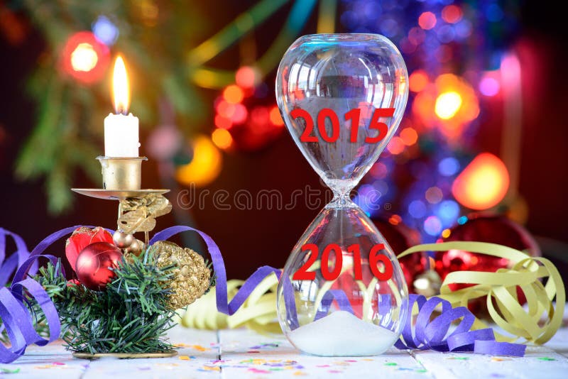 New Year 2016 concept with hourglass and Christmas decoration. New Year 2016 concept with hourglass and Christmas decoration