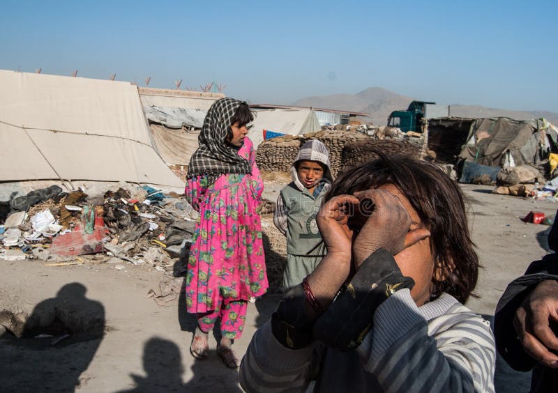 Kuchi children look on with inquisitive eyes at visitors to their makeshift home in the Kabul outer regions. These transient people will seasonally move on to pastures new. Kuchi children look on with inquisitive eyes at visitors to their makeshift home in the Kabul outer regions. These transient people will seasonally move on to pastures new