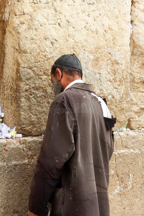 Unidentified poor man praying at the Wailing wall (Western wall). Unidentified poor man praying at the Wailing wall (Western wall)