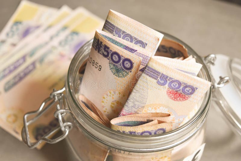 Nigerian Five hundred naira notes in jar for savings concept stock image Nigerian Five hundred naira notes in jar for savings concept stock image
